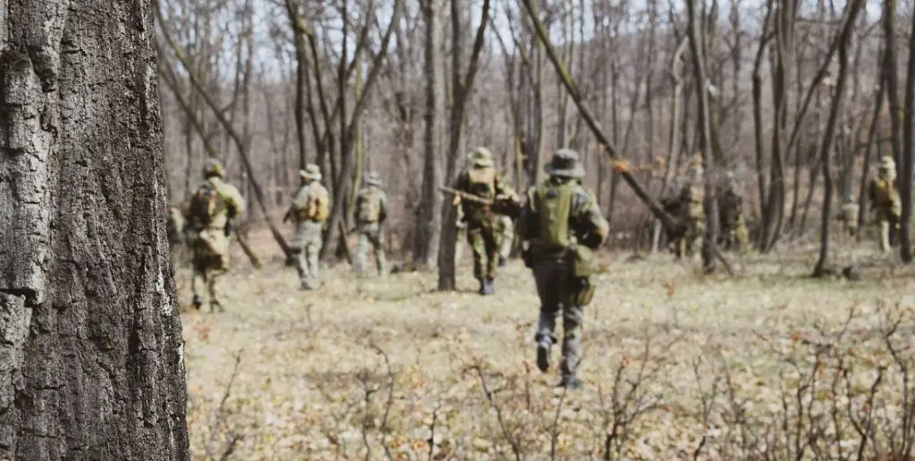 fireteam marching in forest airsoft